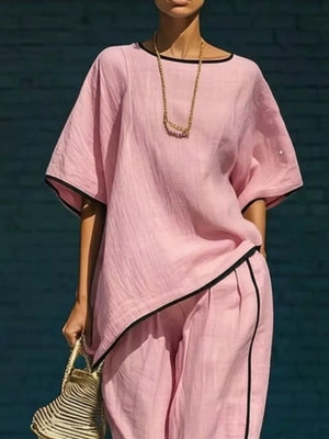 Pink two-piece set with contrast trim, cropped pants, and loose top.