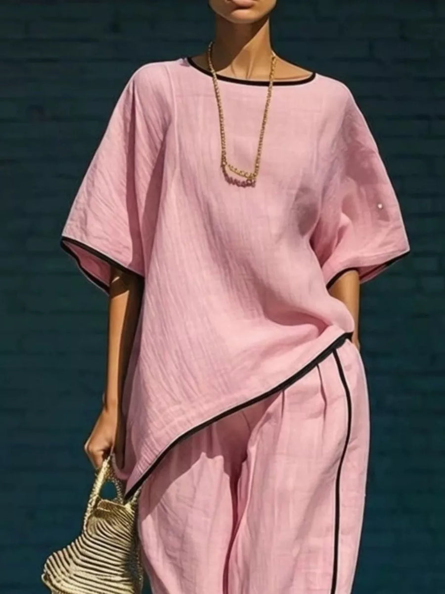 Pink two-piece set with contrast trim, cropped pants, and loose top.