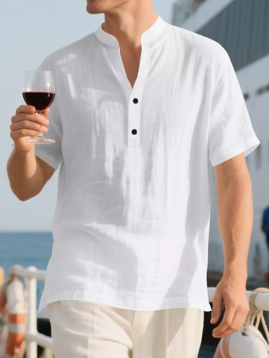 White linen blend men's shirt with band collar and black buttons, short sleeves.