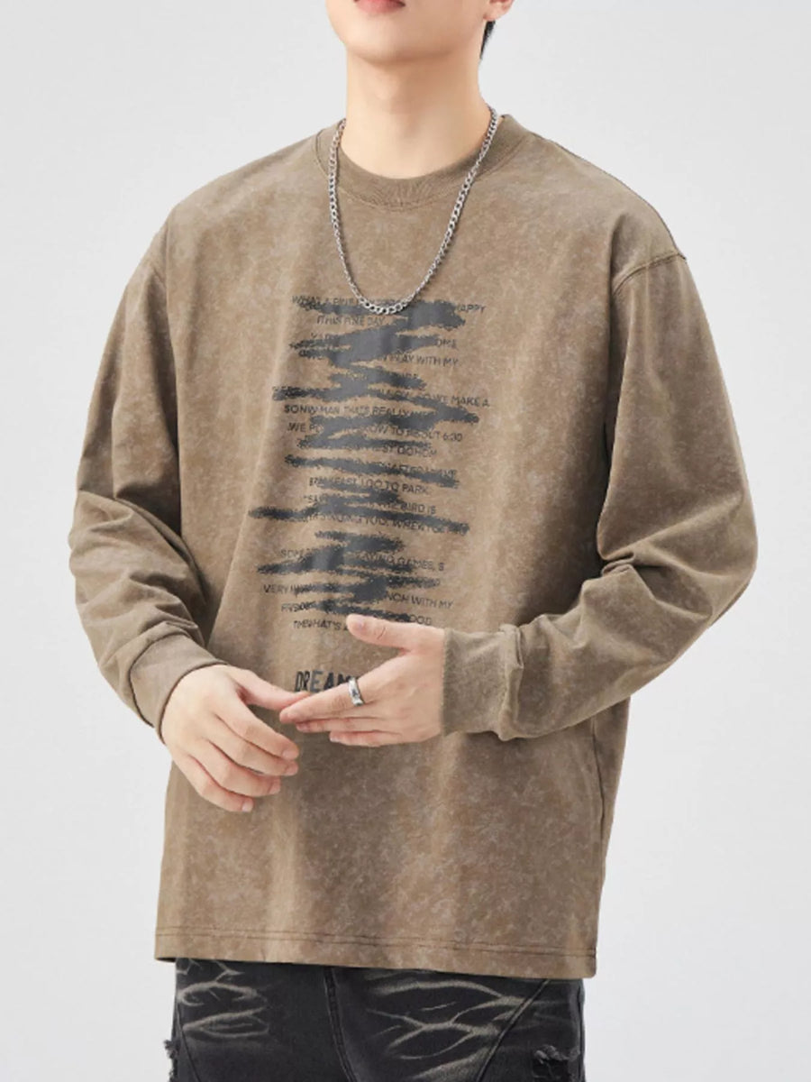 Brown oversized long-sleeve tee with graphic text print and distressed wash.