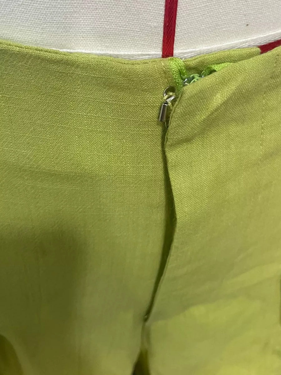 Sophisticated high-waist flowing pants in lime green with a zipper detail.