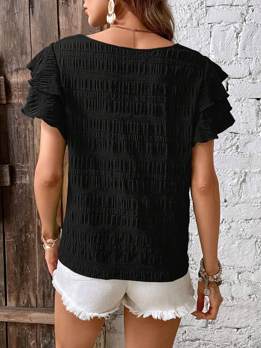 Black textured smocked blouse with ruffle sleeves, 100% polyester