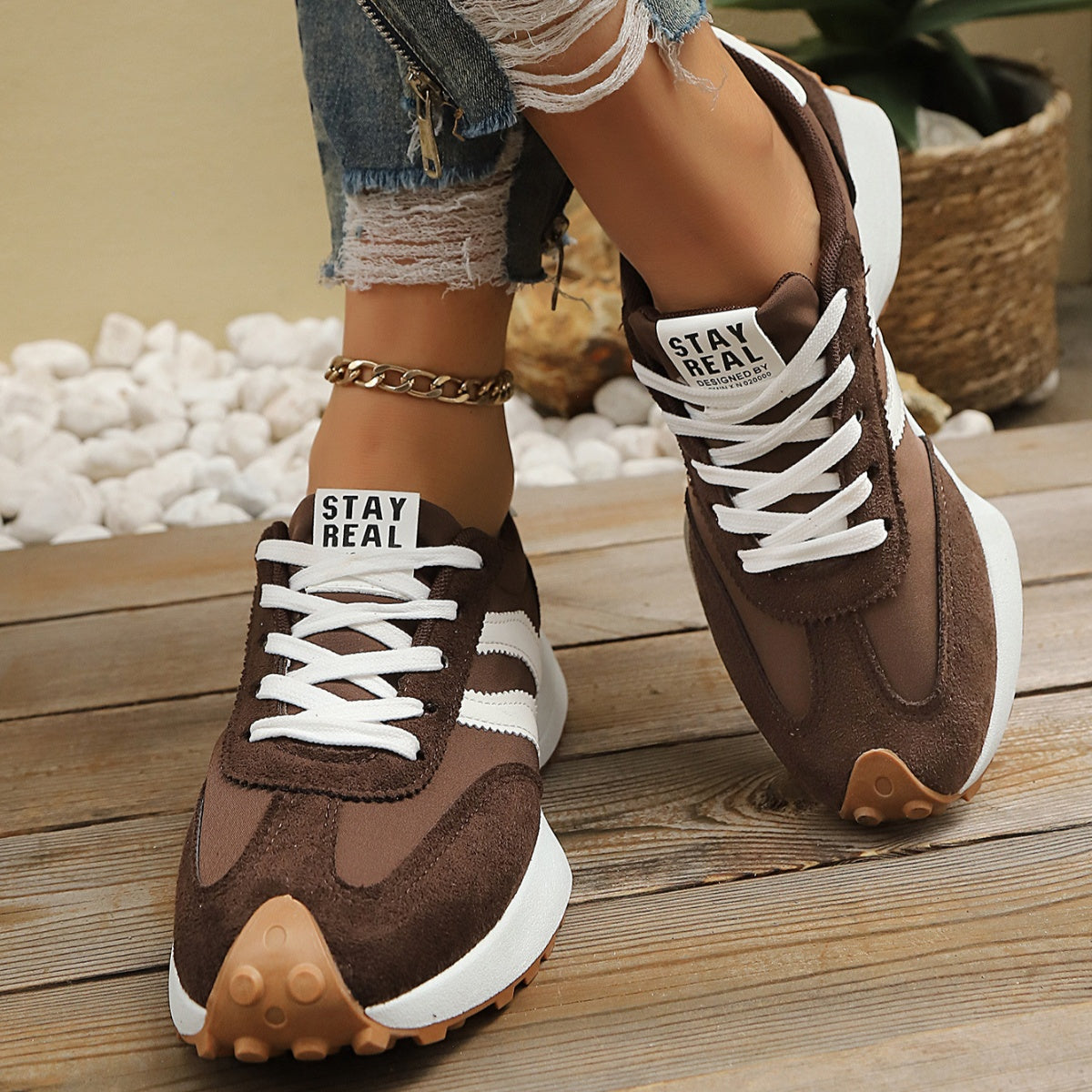 Brown lace up round toe sneakers with white stripes and chunky sole