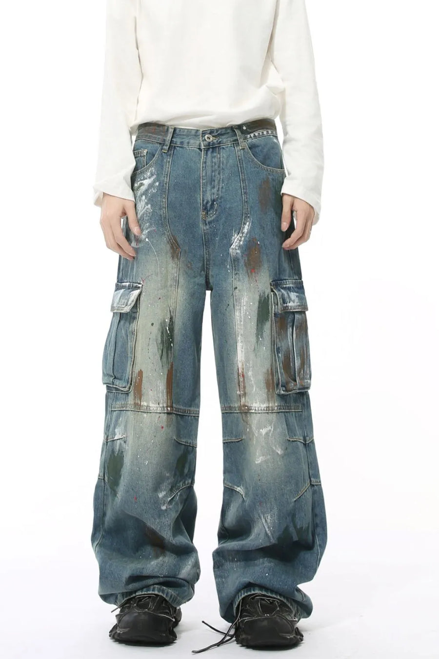 Artisan denim cargo pants in medium wash with paint splatters and wide legs.