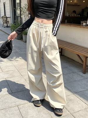 wide-leg pants in cream featuring drawstring waist and loose fit