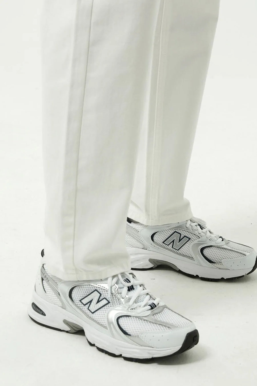 Relaxed fit ivory denim trousers with a straight leg, styled with white sneakers.