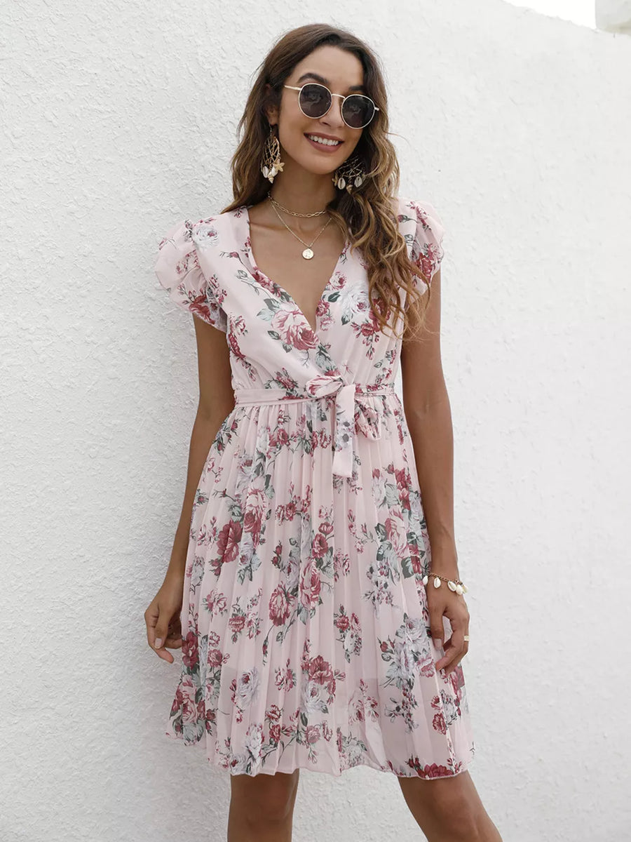 Blush pink floral pleated dress with ruffle sleeves and tie waist