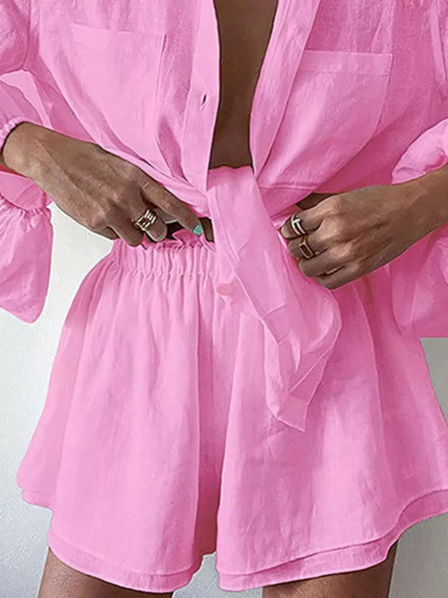 Pink relaxed two-piece shirt and shorts set with tie-front shirt and elastic waist shorts.