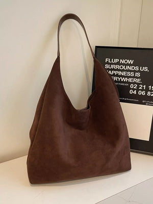 Brown suede hobo bag with a single strap and slouchy silhouette