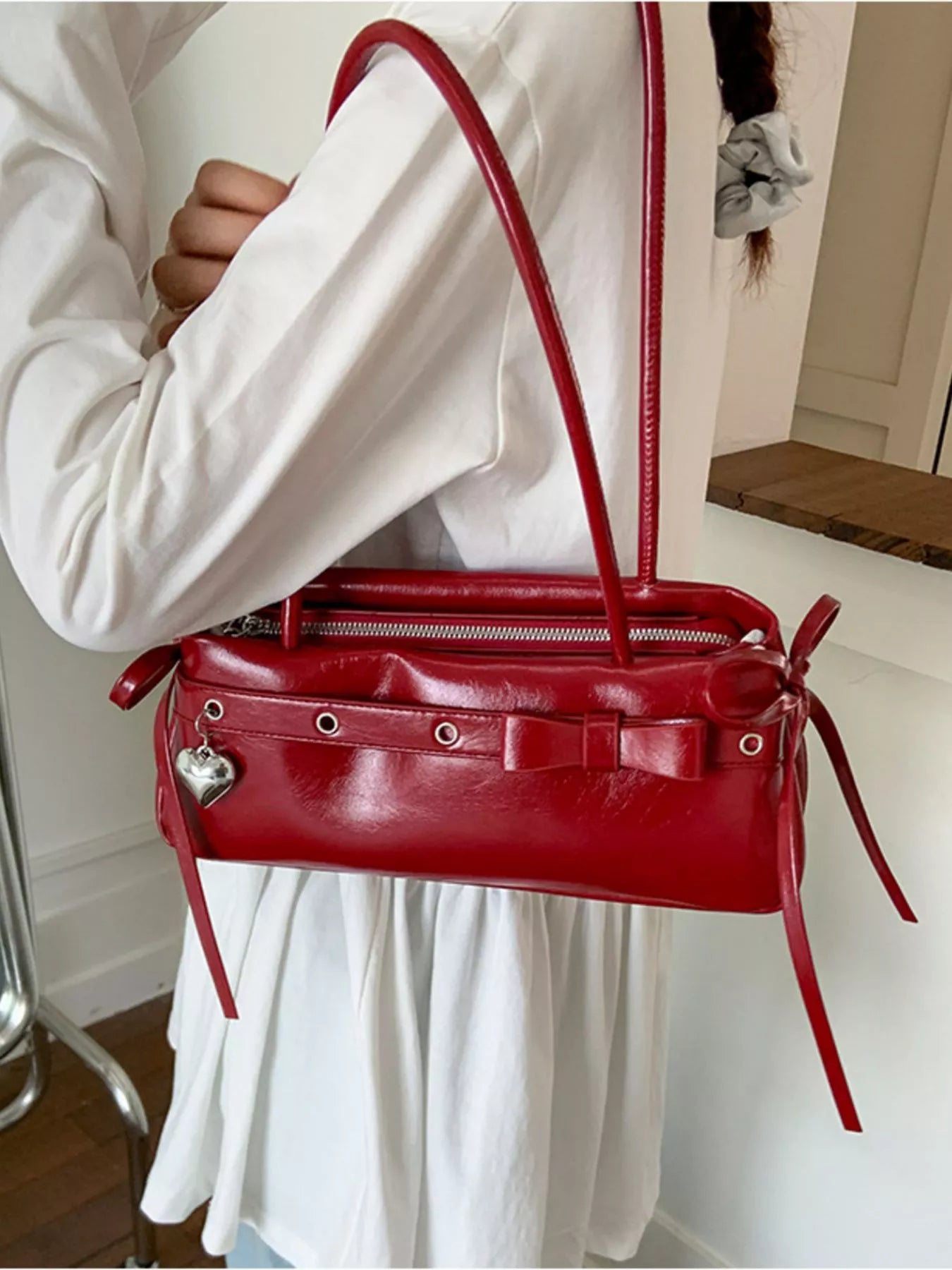 Red PU leather shoulder bag with bow detail and heart charm