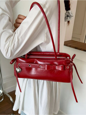 Red PU leather shoulder bag with bow detail and heart charm