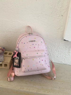 Blush pink mini backpack with colorful star print and a photo charm.