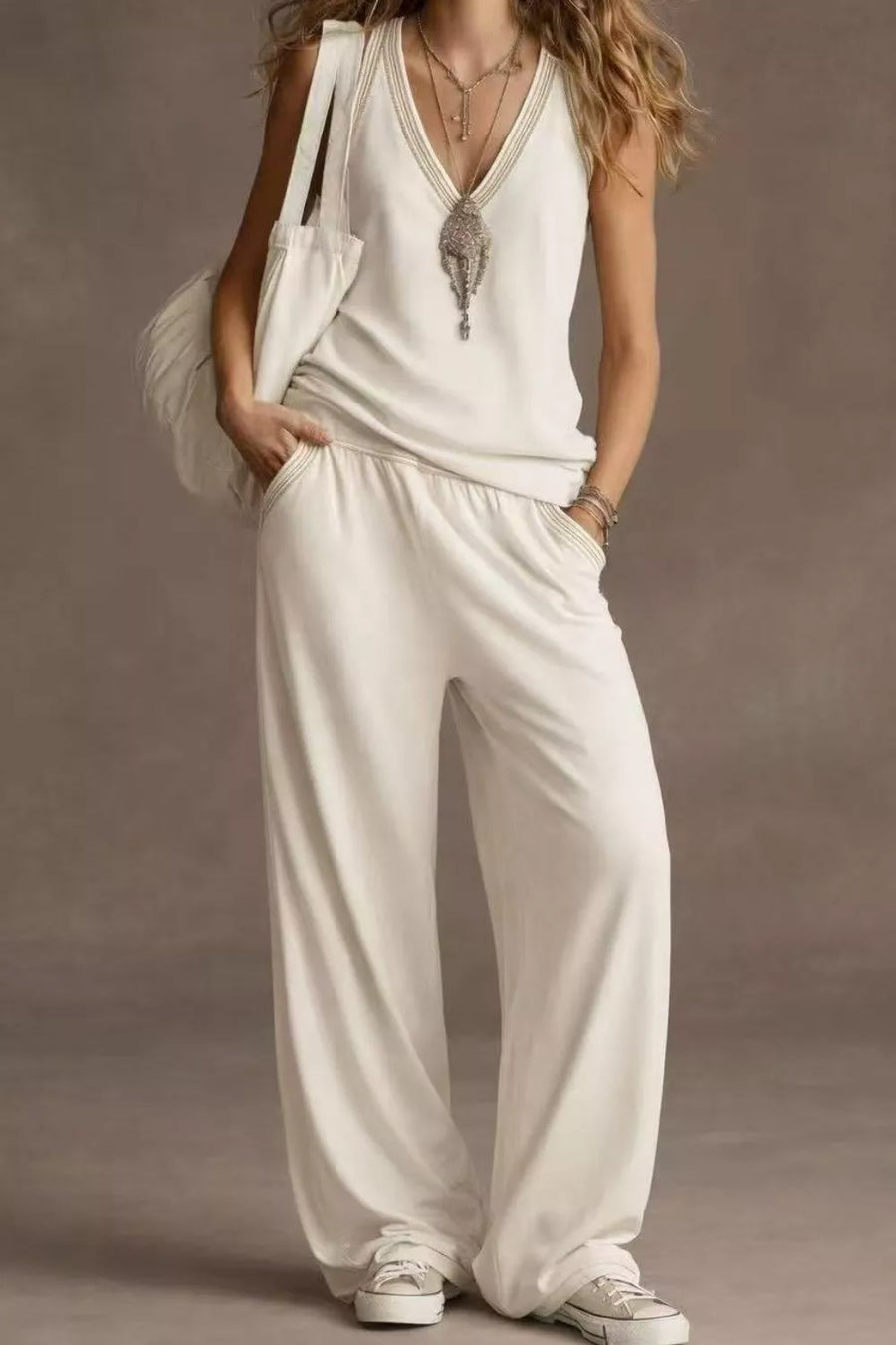 White V-neck tank top and wide-leg pants set with elastic waist and beaded trim.