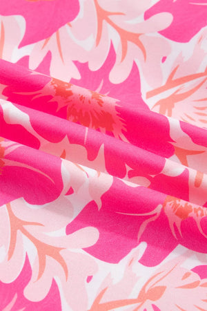 Polyester blouse with vibrant pink and orange floral print and ruffled detail.