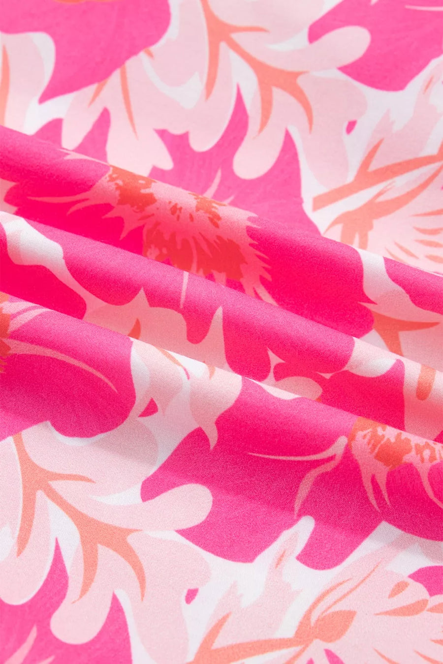 Polyester blouse with vibrant pink and orange floral print and ruffled detail.