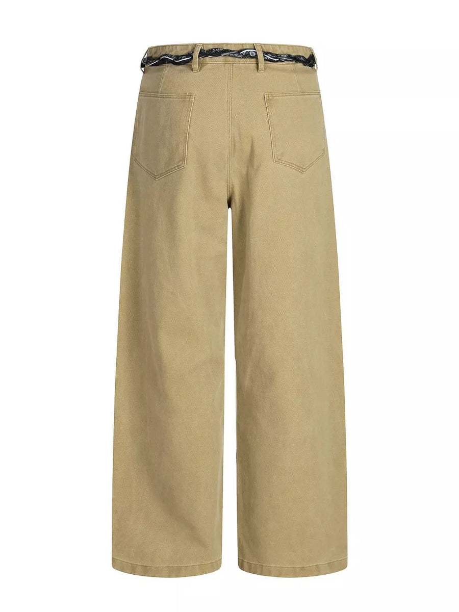 Belted wide-leg maternity pants in tan with a decorative black and white belt.