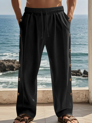 Black linen palazzo trousers with side buttons and drawstring waist.