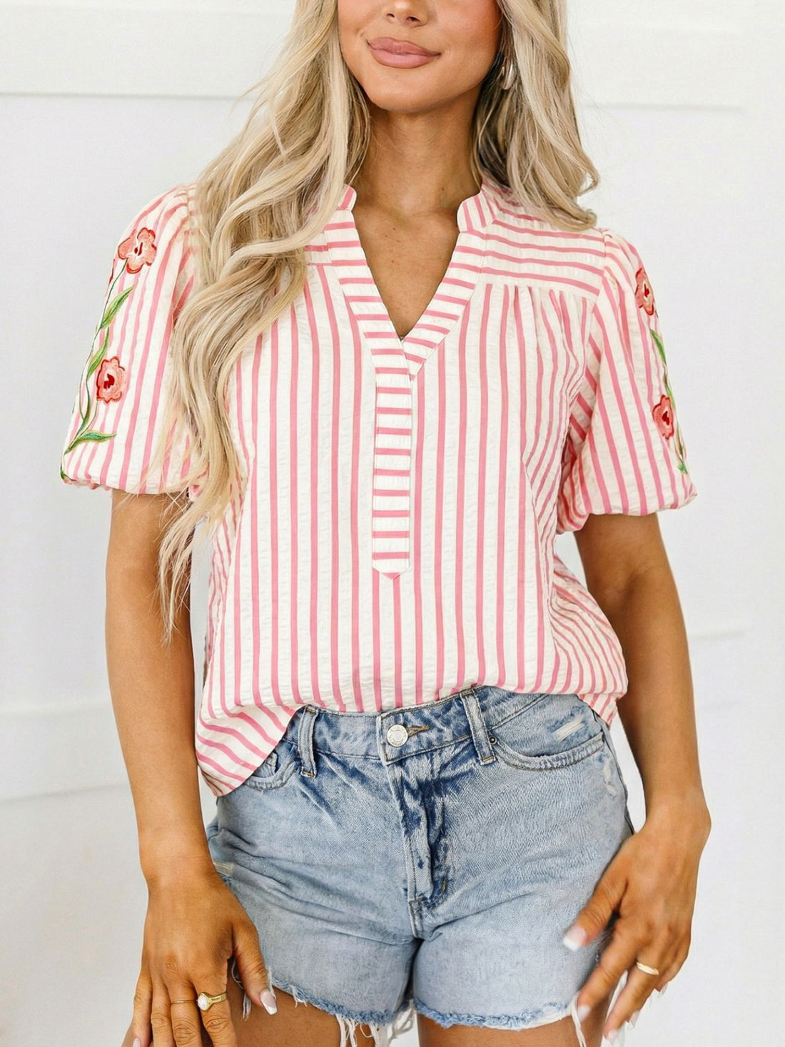 Pink striped blouse with floral embroidered puff sleeves and split neckline