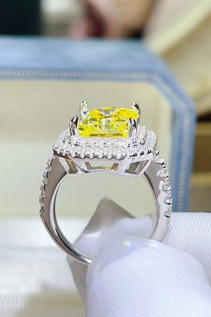 Yellow radiant cut halo ring with canary moissanite and diamond accents.