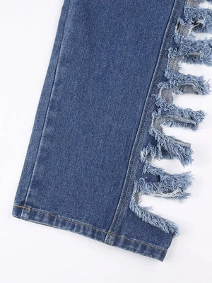Blue denim jeans with distressed side cutouts and frayed fringe detail