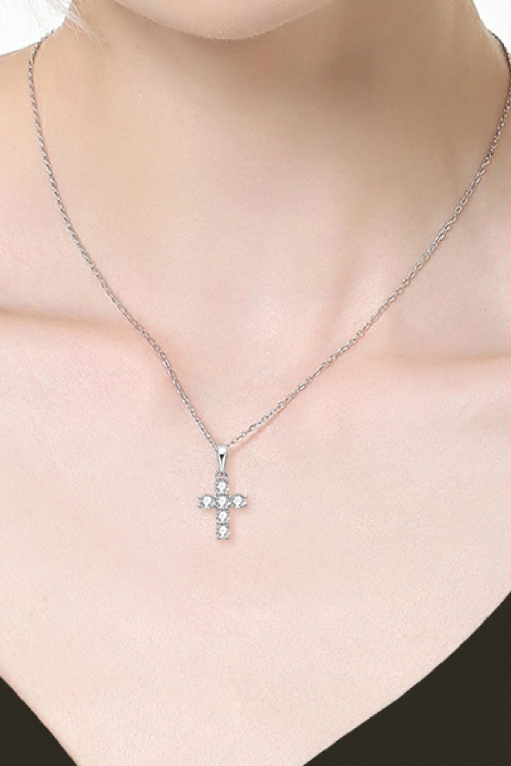 Silver 925 sterling silver cross pendant necklace with delicate glittering stones.