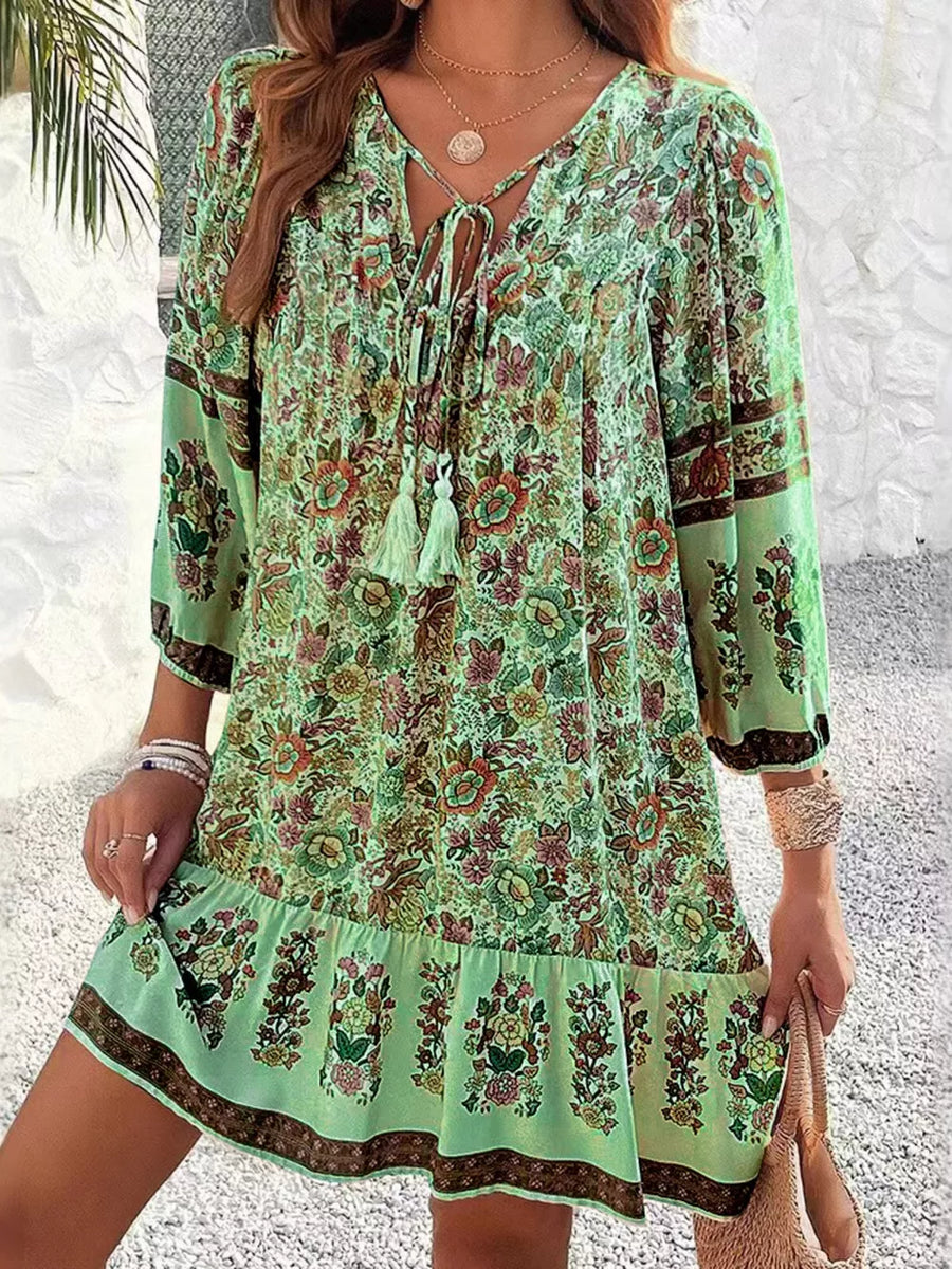 Matcha green floral mini dress with tassel tie neckline and tiered hem