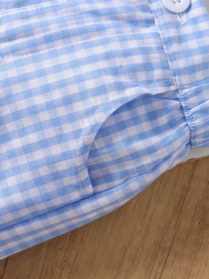 Blue gingham cotton shorts with a pocket detail and button closure.