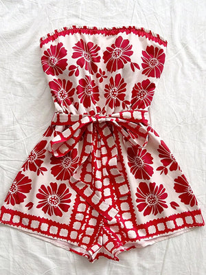 Red floral tie-waist strapless maternity romper with a ruffled hem.