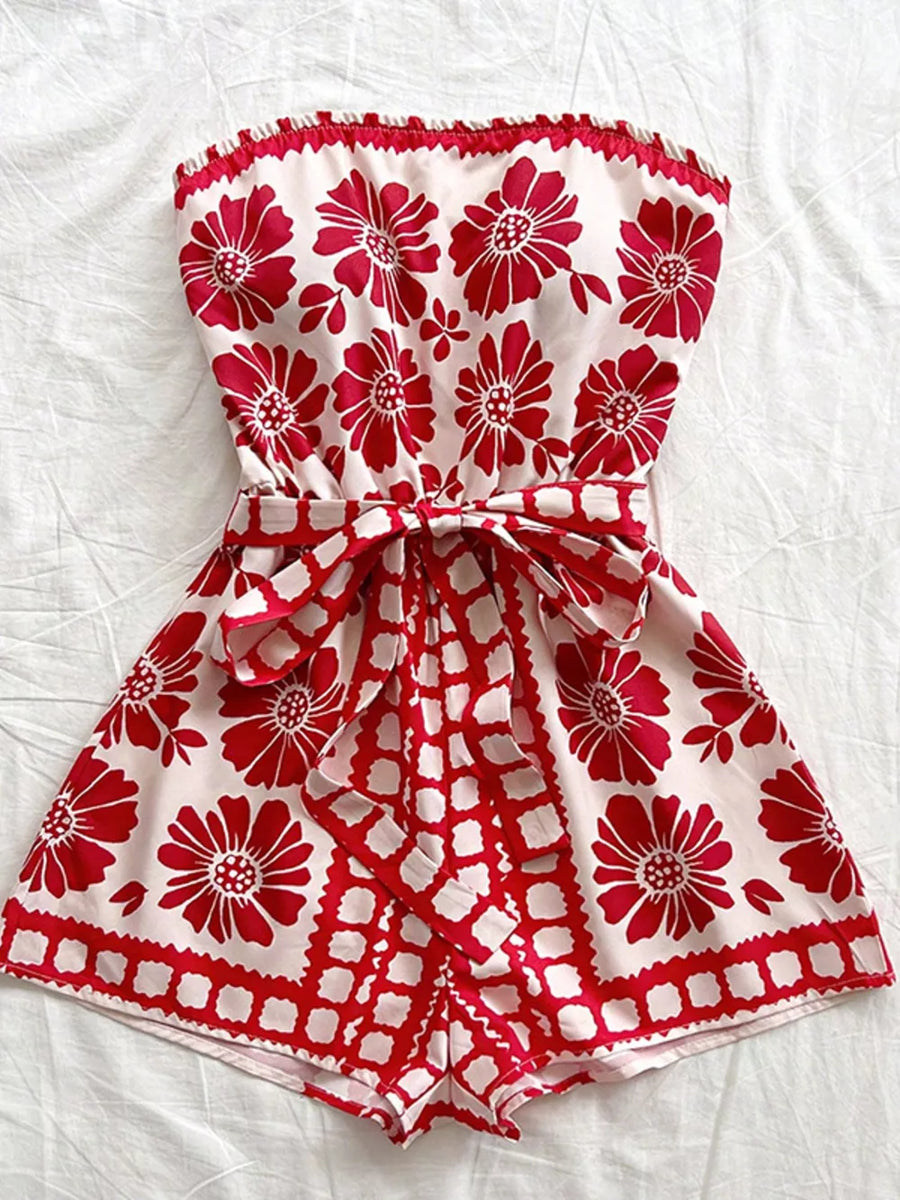 Red floral tie-waist strapless maternity romper with a ruffled hem.
