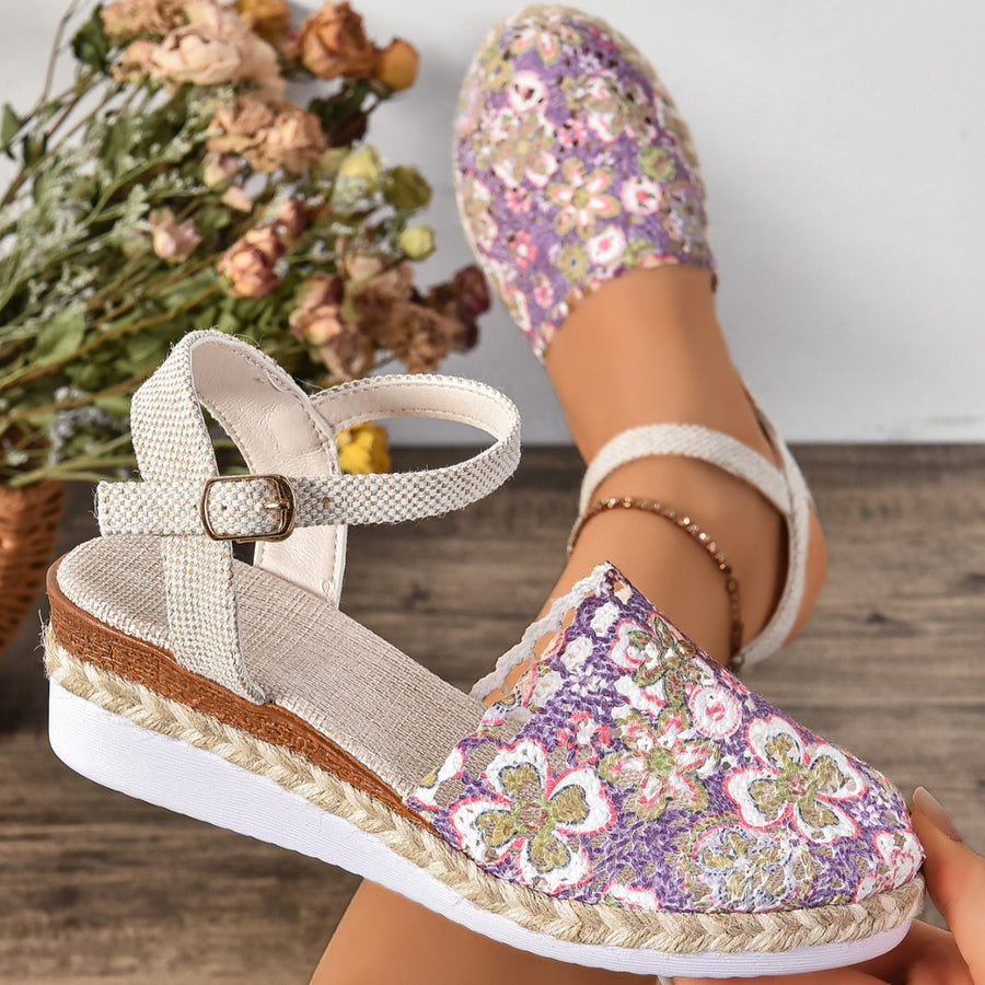 Floral espadrille wedge sandals with adjustable strap and round toe in purple.