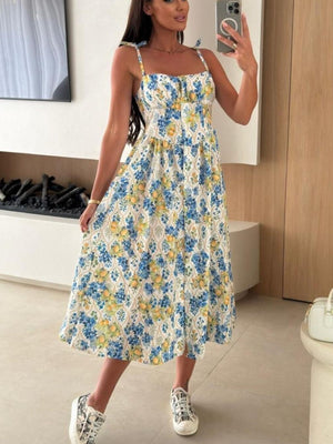 Tie-shoulder midi dress with blue and yellow floral print and adjustable straps.