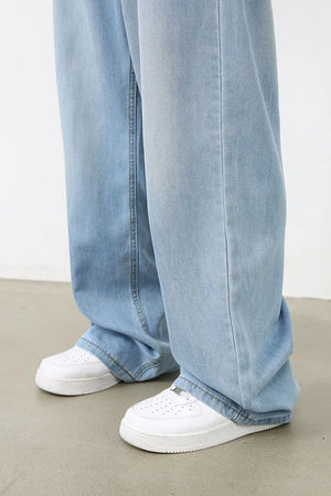 Light blue denim palazzo jeans with a wide leg and casual styling.