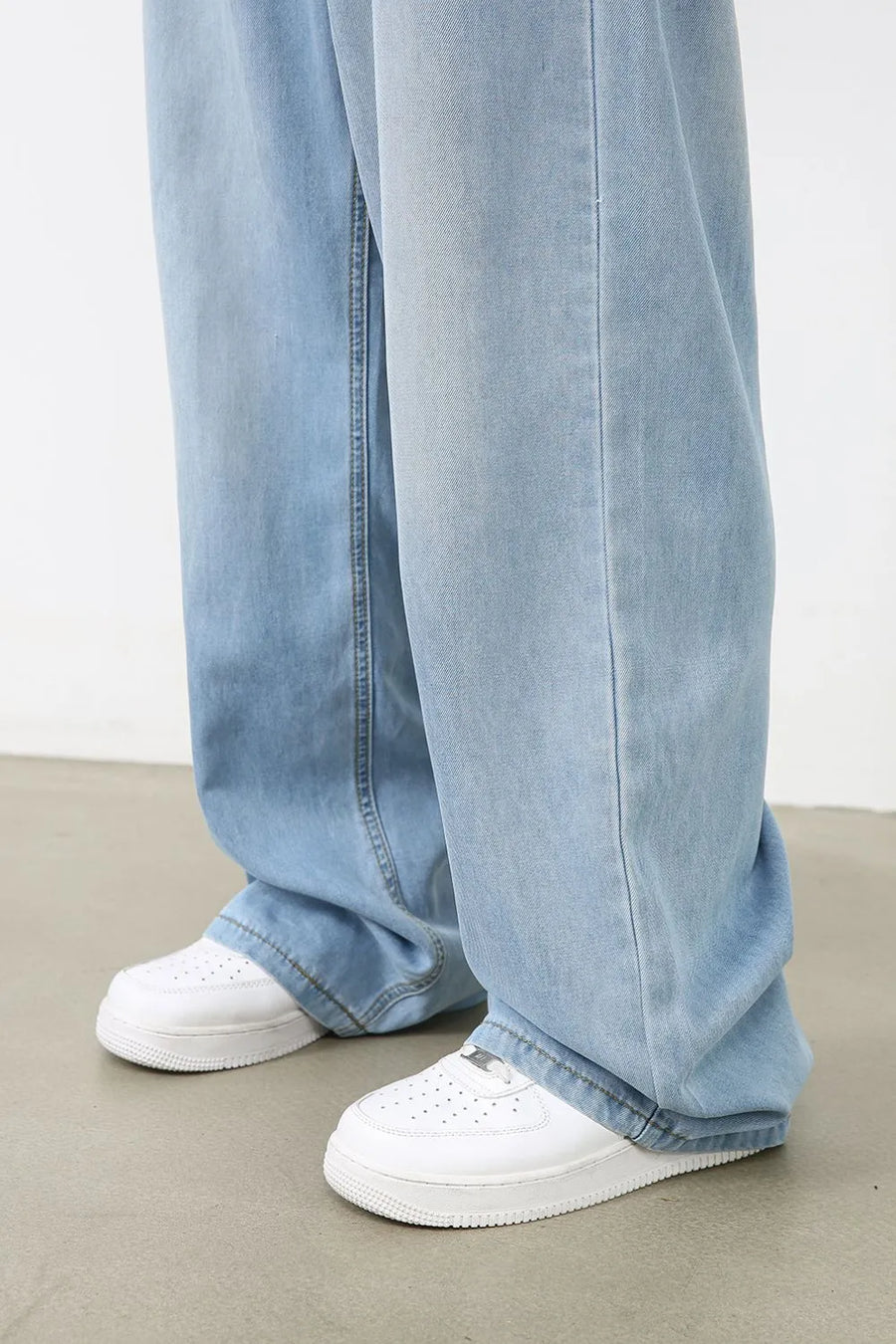 Light blue denim palazzo jeans with a wide leg and casual styling.