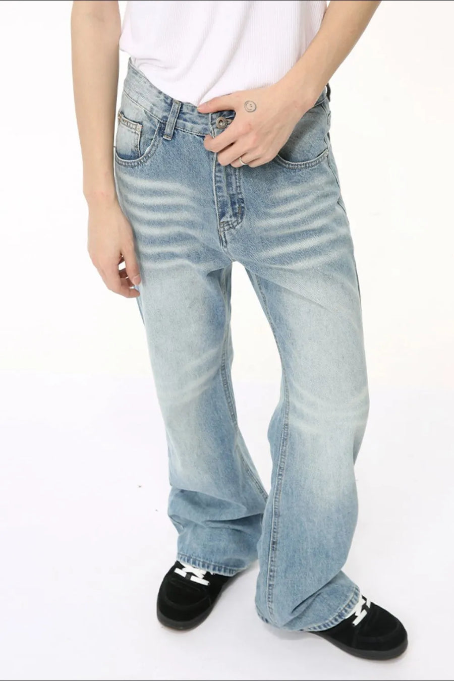 Wide leg washed denim trousers in medium blue with a relaxed fit and faded details.