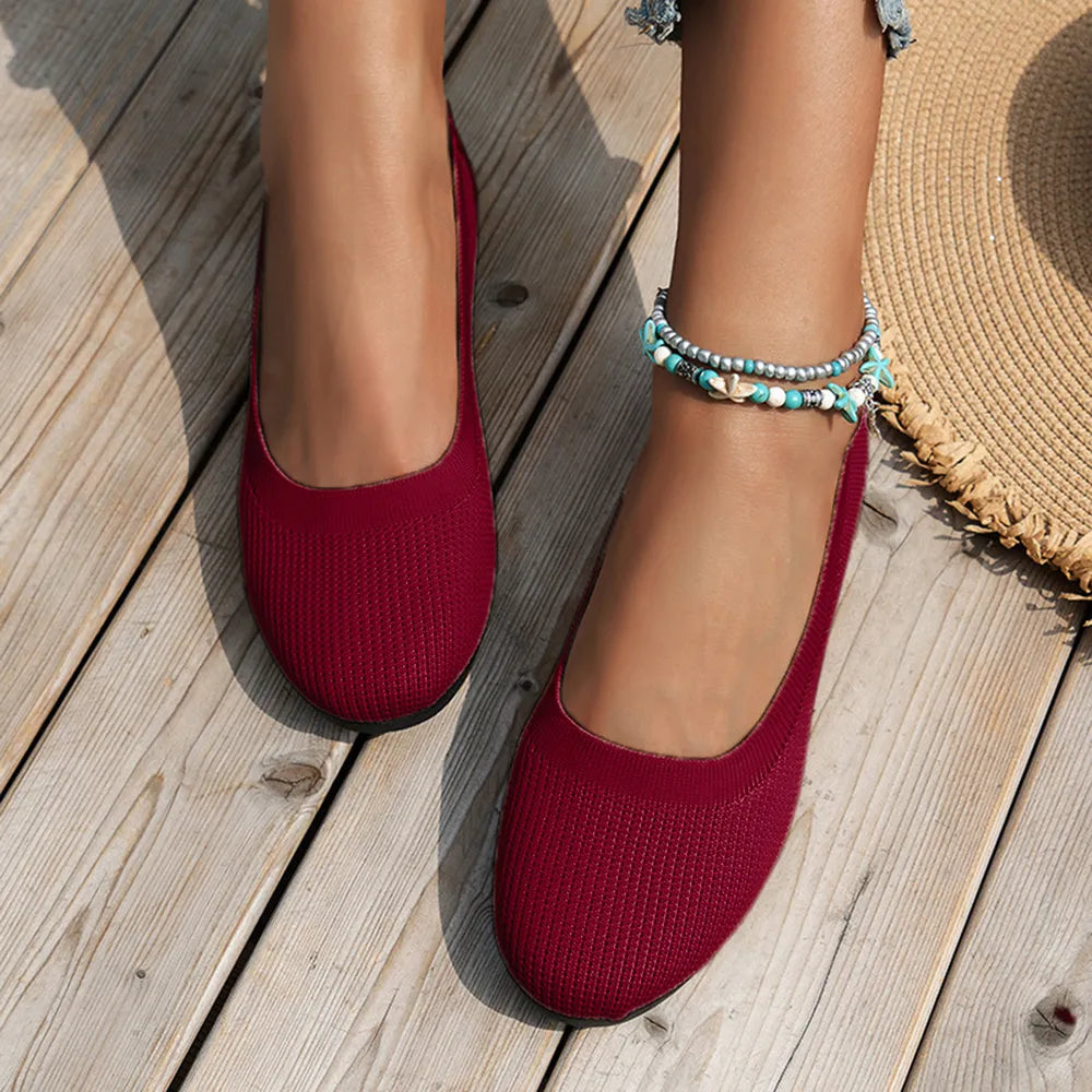 Burgundy textured knit slip-on flats with a rounded toe and low heel.