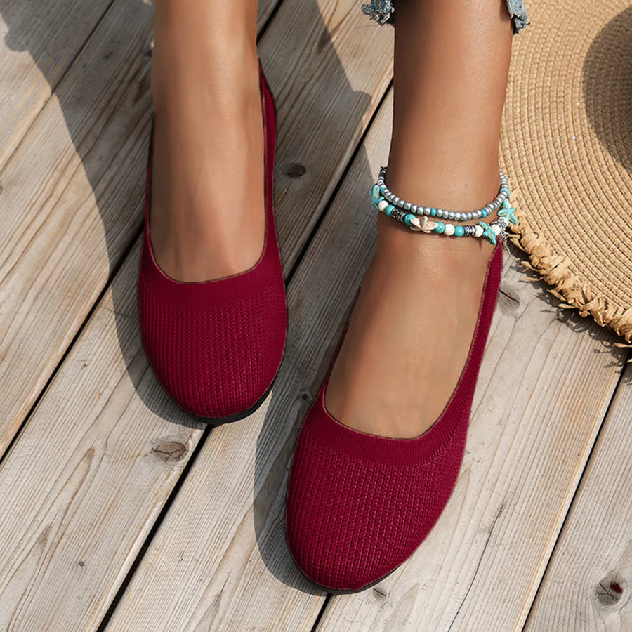 Burgundy textured knit slip-on flats with a rounded toe and low heel.