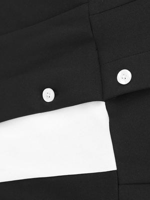 Button-down wide leg jumpsuit in black and white with white buttons.