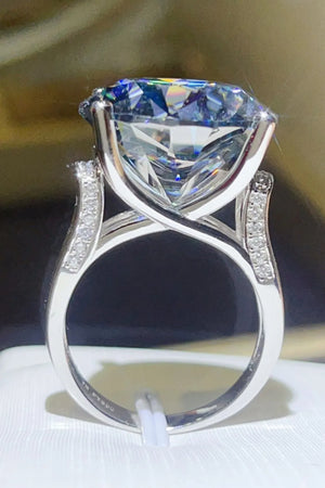 Royal blue moissanite cocktail ring with diamond accents on a silver band.