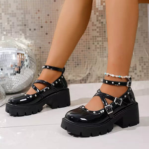Black patent platform Mary Jane sneakers with studded straps and chunky heel.