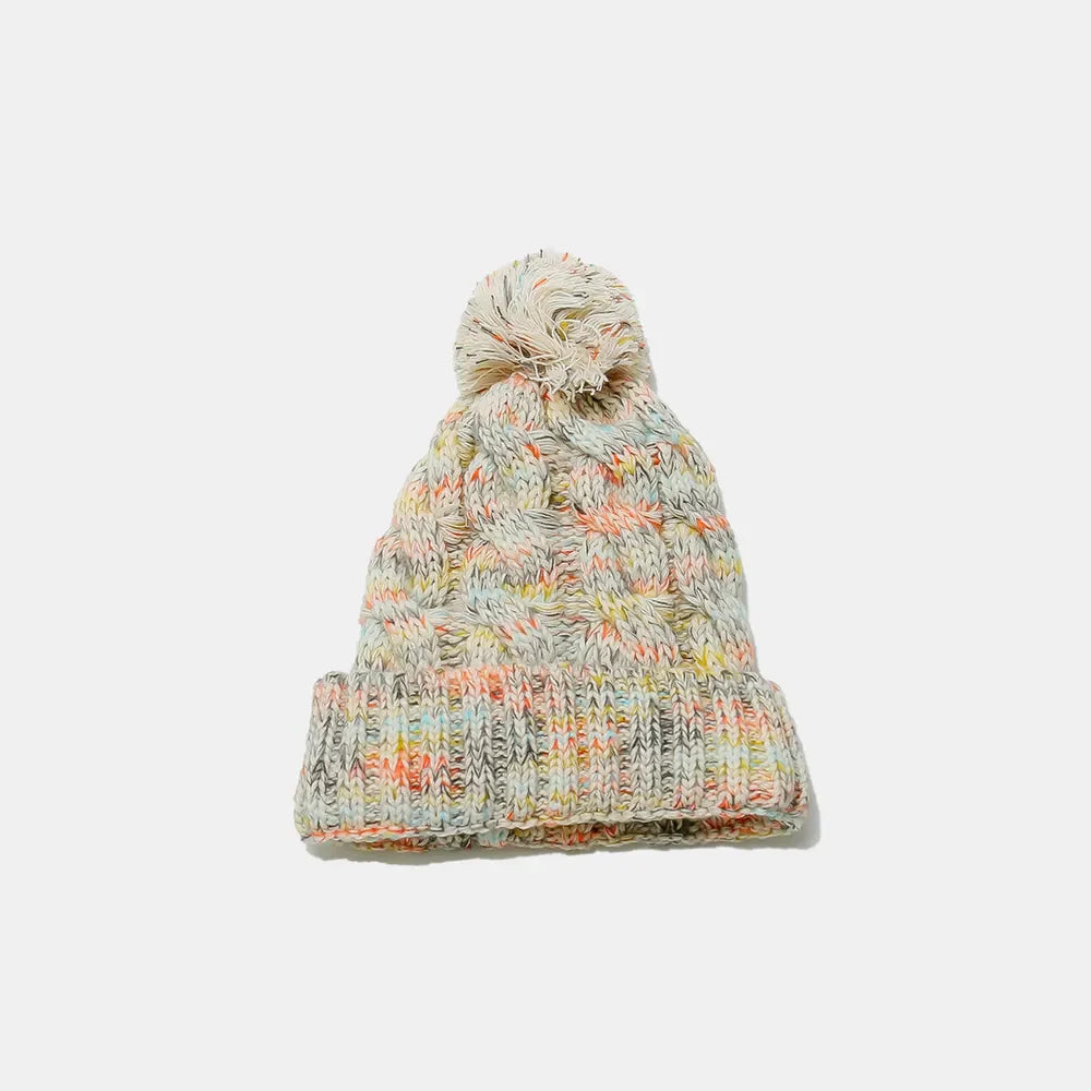 Textured knit pom beanie with cable detail and multi-color flecks.