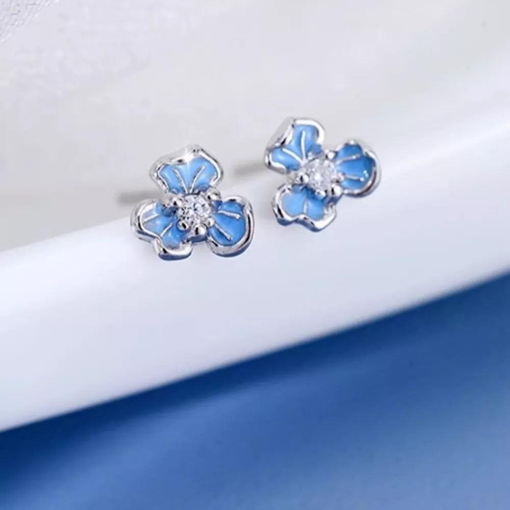 light blue earrings with floral and N/A