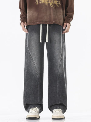 Relaxed fit wide-leg jeans in dark gray denim with drawstring waist and contrast stitching.