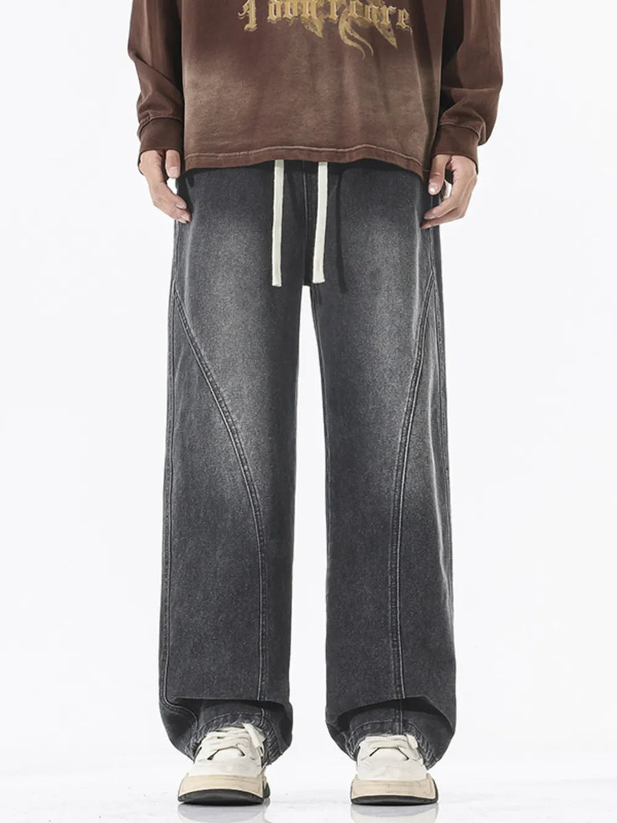 Relaxed fit wide-leg jeans in dark gray denim with drawstring waist and contrast stitching.