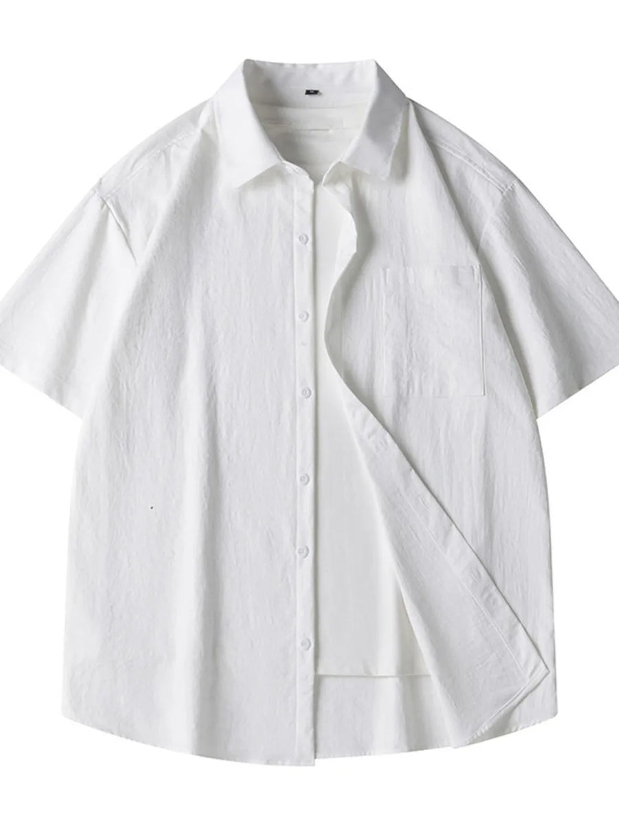 White relaxed fit button-up shirt with short sleeves and chest pocket.