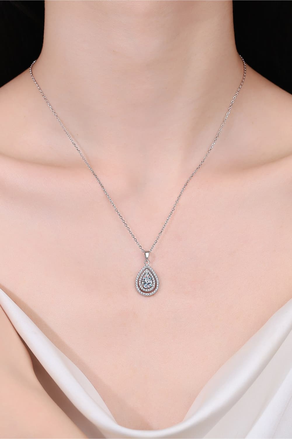 Silver double halo moissanite teardrop necklace on a sterling silver chain.