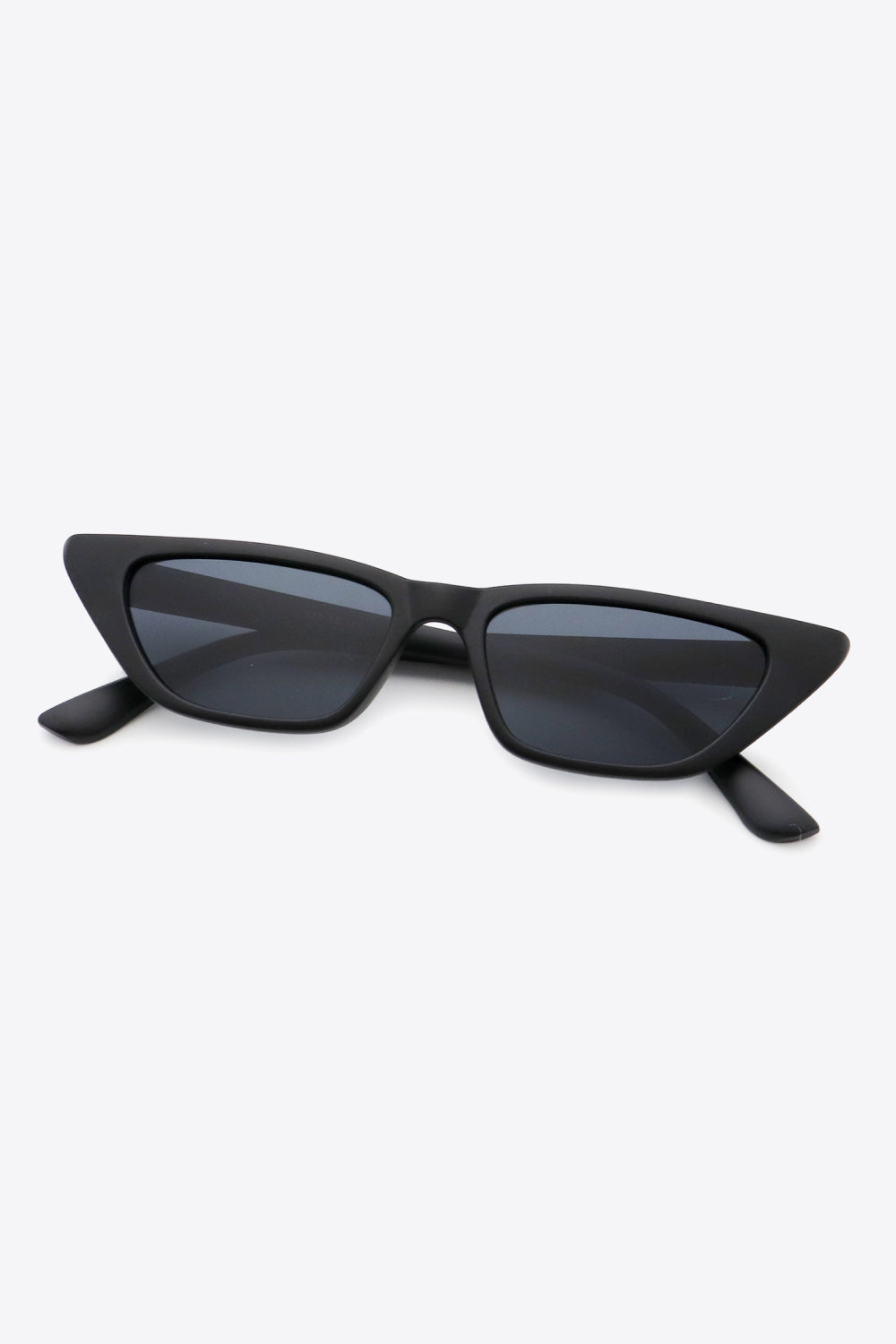 Black cat eye sunglasses with angular frames and dark lenses.