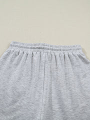 Light grey polyester lounge shorts with elastic waistband and drawstring detail.