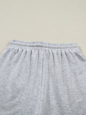 Light grey polyester lounge shorts with elastic waistband and drawstring detail.