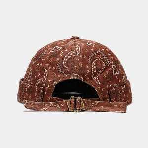 rust brown hat featuring adjustable strap and paisley