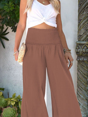 Light Brown smocked waist wide-leg trousers with a textured fabric.